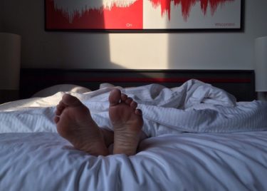 The feet of a person sleeping on their back