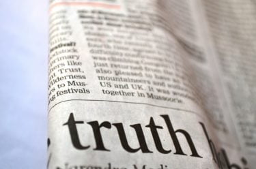 news paper with the word truth in large writing