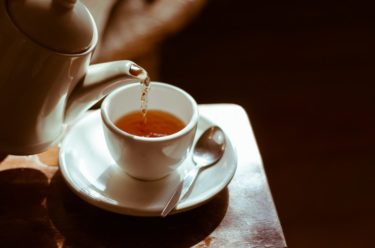 Image of a pot of tea being poured into a tea cup