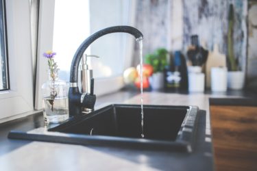 A kitchen tap running water