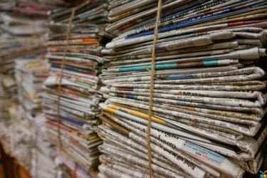 A stack of newspapers tied with string