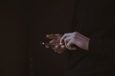 A pair of hands hold a smartphone