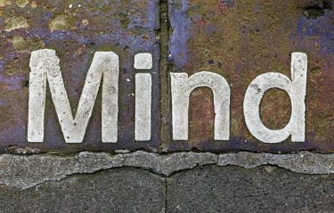 The word mind written on paving slabs