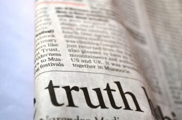 a folded newspaper reading the word "truth"