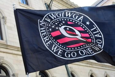 A Qanon flag at a rally in Virginia with the tag line "Where We Go One We Go All". Image by Anthony Crider (CC-by-2.0)