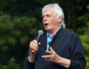 David Icke holding a microphone and speaking. Photo by Tyler Merbler [CC-by-2.0]