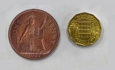 A penny along side a thrupenny - the penny, though much larger, is worth three times less than the thrupenny.