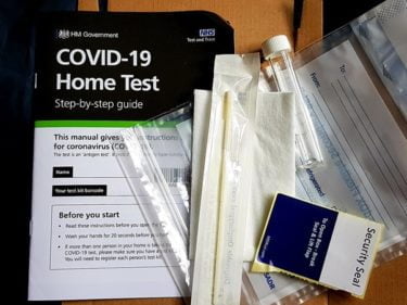 A COVID Home Test Kit from the UK Government and the NHS. The kit contains a sterile swab, a plastic sample bag, a labelled tube with a lid to put the swab inside and an instruction booklet. [CC-by-SA-4.0] image by Wikimedia user Fae.