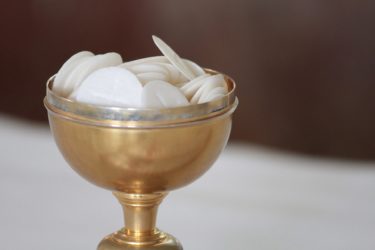 A gold bowl containing Eucharist