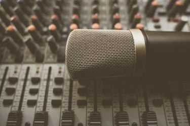 A microphone laid on a sound desk