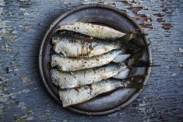 A plate of cooked sardines