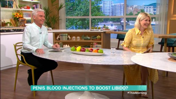A screen shot of the TV show This Morning with Phillip Schofield and Holly Willoughby sitting at a table giggling. The chyron reads: "Penis blood injections to boost libido?"
