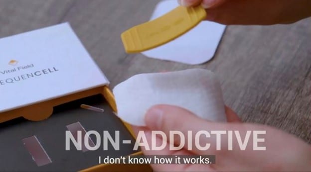 A still shot from an advert for the "Vital Field Frequencell" product, including a box, a white cotton-looking pad, and a yellow plastic strip. Overlaid on the image, from present in the advert itself, is the text: "Non-Addictive. I don't know how it works."