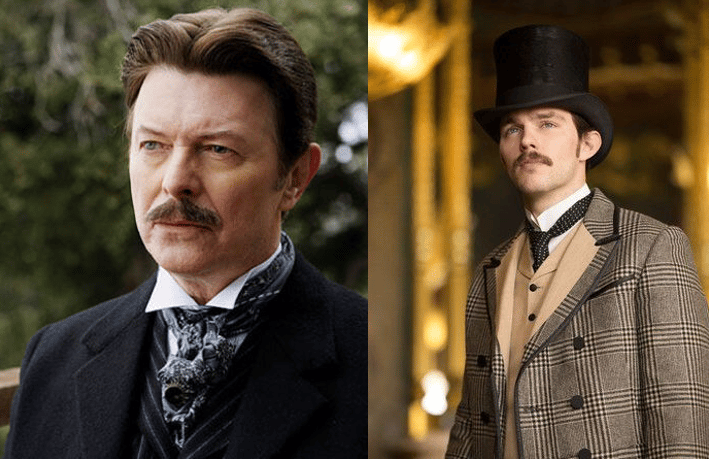On the left David Bowie as Nikola Tesla in The Prestige, on the right Nicolas Hoult as Nikola Tesla in The Current War. Both portrayals show Tesla as a slim man with brown hair and a brown moustache. In both cases the actors wear a white shirt with a waistcoat and blazer over the top and a tie or cravat around the neck. Hoult's Tesla wears a top hat. 