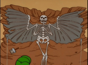 A cartoon skeleton with wings and arms excavated in the ground