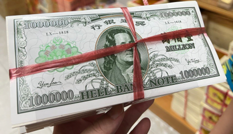 a stack of "hell bank note"s tied together with red ribbon. 