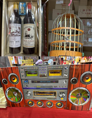 A paper bird cage, wine bottles and a hi-fi system. 