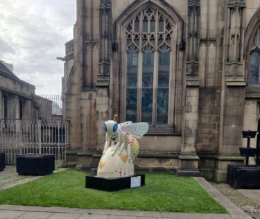A bee statue outside of Manchester Cathedral