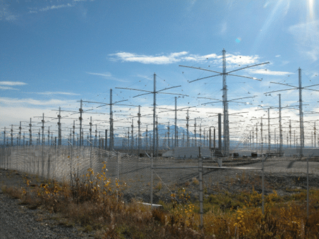 The HAARP antenna array - a vast sea of antennae stretching far into the distance, surrounded by barbed wire fence.