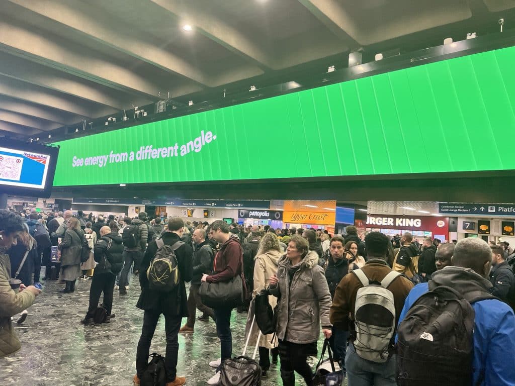 The bright green advertising board in Euston station