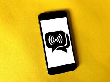 A mobile smartphone with speech bubbles on the screen indicating messaging. 

Photo by Franck on Unsplash

