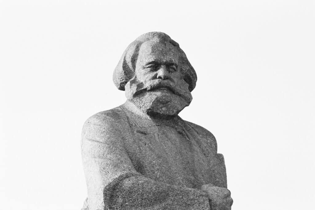 Statue of Karl Marx, photo in black and white, his torso upwards visible.
