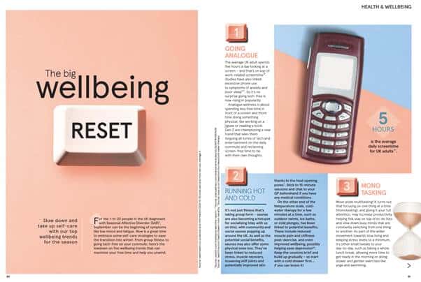 Screenshot of a Tesco magazine feature called 'The big wellbeing RESET' in which the reset word is printed on an image of a keyboard key. The opposite spread shows an old mobile phone, and the piece is branded in peach and baby blue colours. Headings read 'Going analogue', 'Running hot and cold' and 'Mono tasking'