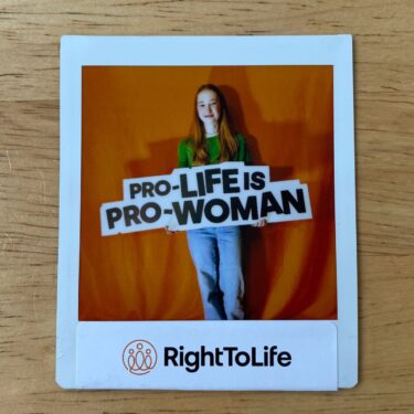 A RightToLife card with an image of a woman holding a large sign saying "Pro-Life is Pro-Woman".