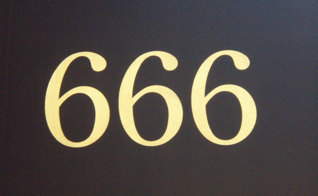 Three number sixes printed flag on a black door