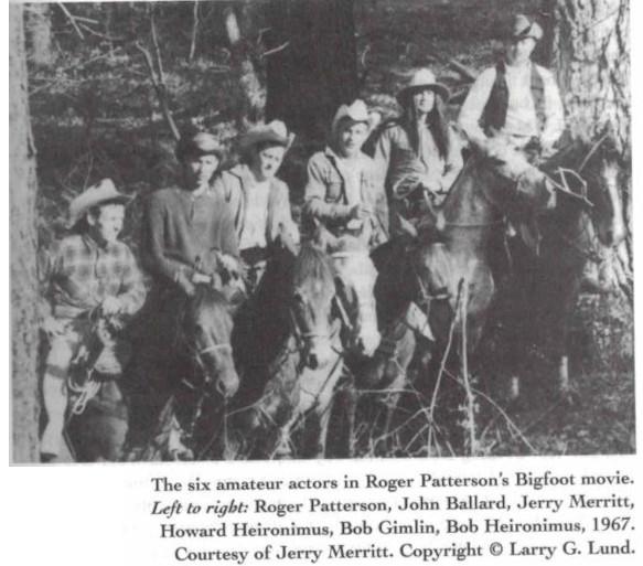 A black and white photograph of six men in cowboy hats on horseback in a forest. The caption reads "The six amateur actors in Roger Patterson's Bigfoot movie. Left to right: Roger Patterson, John Ballard, Jerry Merritt, Howard Heironimus, Bob Gimlin, Bob Heironimus, 1967. Courtesy of Jerry Merritt. Copyright (c) Larry G. Lund."