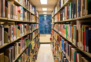 Rows of full bookshelves in a library.