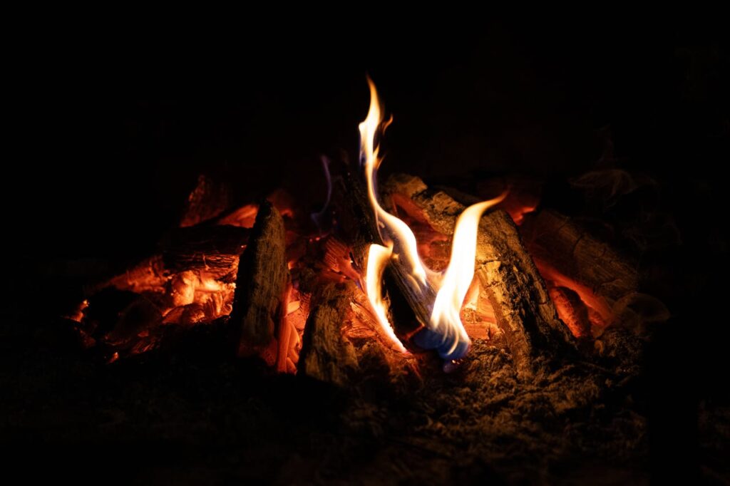 Branches burning on a campfire at night