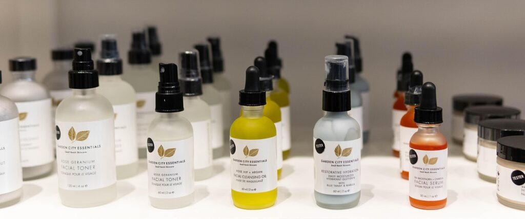 A shelf holding an array of skincare products; serums, cleanser, toner etc. all arranged in neat rows and carefully branded