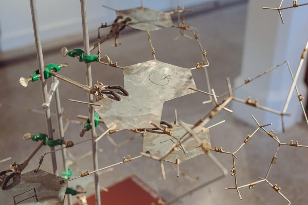 A replica of the metallic DNA double helix model made by James Watson and Francis Crick during their characterisation of the DNA molecule. Metallic base-shapes are held in place by lab clamps.