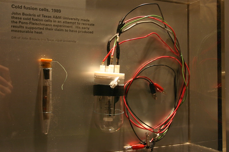 Photograph of a museum exhibit. Two glass vessels, one of which has several wires secured to its top.
A panel reads "Cold Fusion cells, 1989. John Bockris of Texas A&M University made these cold fusion cells in an attempt to recreate the Pons-Fleischmann experiment. His early results supported their claim to have produced measurable heat. Gift of John Bockris, Texas A&M university."