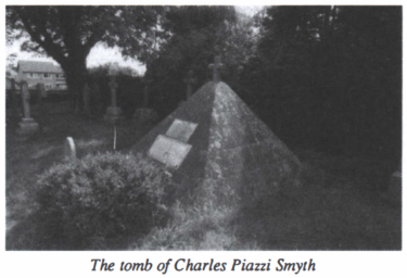 Black and white photograph captioned "The tomb of Charles Piazzi Smyth"

In a churchyard among conventional headstones is a stone pyramid built of blocks. The pyramid has two plaques on one face, and a small stone cross at the apex.