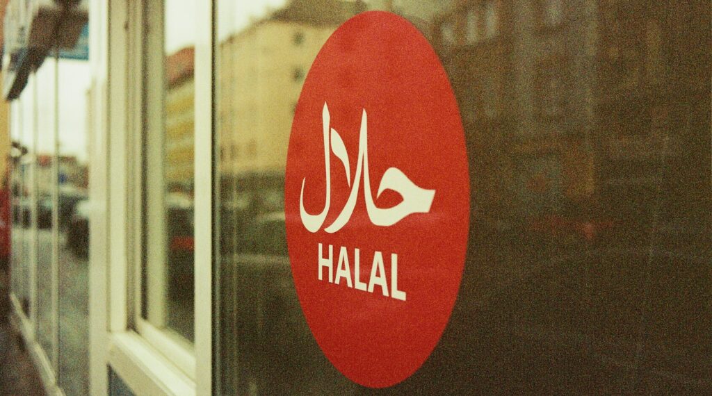 A round, red window decal showing 'HALAL' in white in two languages