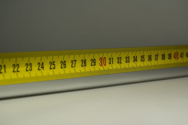 Photograph of an extended steel tape measure, between the 21cm and 42cm marks.